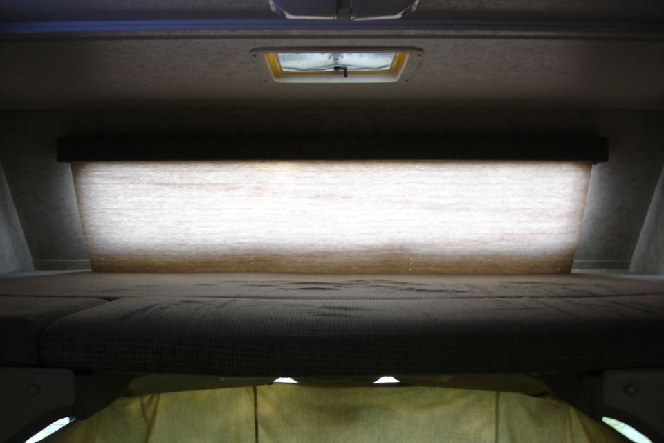 Interior sleeping area with skylight and blinds