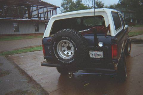 1986 Ford Bronco - Rear view of a 1986 Ford Bronco, a spare tire on the tailgate and a Texas license plate.