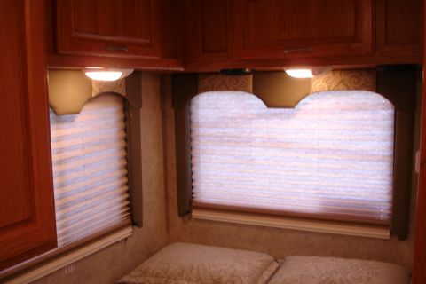 2005 Chevrolet Silverado 3500 - This image shows the interior of a vehicle, possibly an RV, with blinds covering the windows and overhead cabinets.