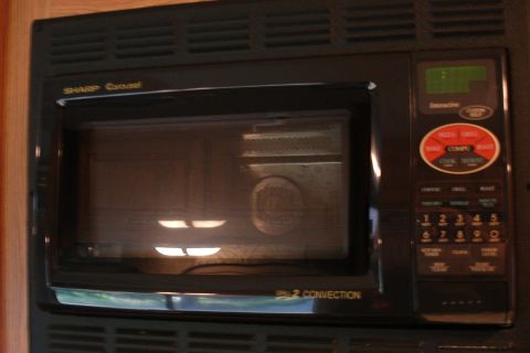 2005 Chevrolet Silverado 3500 - A black Sharp Carousel microwave oven is shown, a digital display and a control panel with various cooking options.