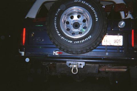 1986 Ford Bronco - Rear view of a 1986 Ford Bronco, a spare tire mounted on the tailgate and a tow hitch.