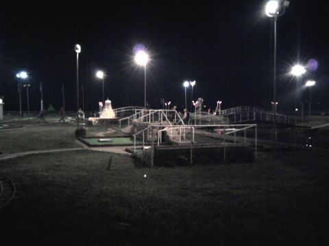 2005 Chevrolet Silverado 3500 - A mini golf course is lit up at night with multiple lamps and pathways visible.