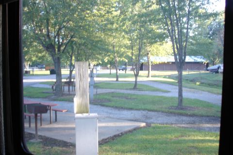 2005 Chevrolet Silverado 3500 - A truck is visible in the distance at a campground with picnic tables and trees.