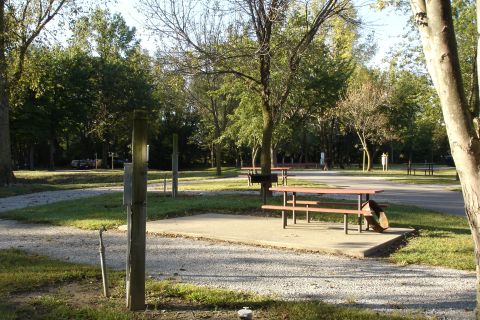 2005 Chevrolet Silverado 3500 - A campsite scene with picnic tables and trees, a vehicle is visible in the distance.