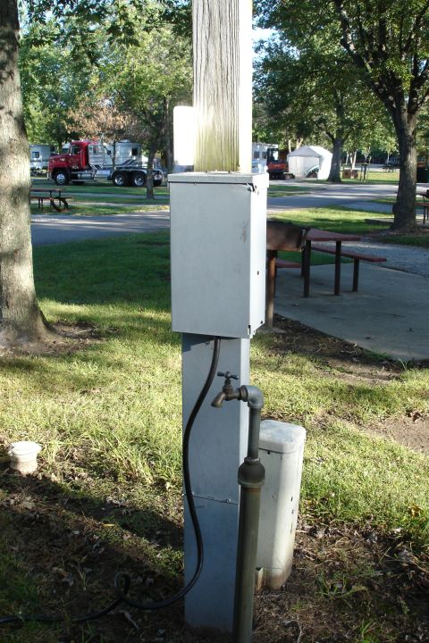 2005 Chevrolet Silverado 3500 - Utility pedestal at a campsite, with RVs and a red truck visible in the background.