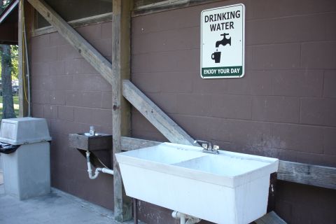 2005 Chevrolet Silverado 3500 - A public drinking water station is shown with a sink, faucet, and a sign indicating 'DRINKING WATER'.