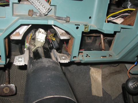 1981 Ford Bronco - The interior of a 1981 Ford Bronco shows exposed dashboard wiring and the steering column.