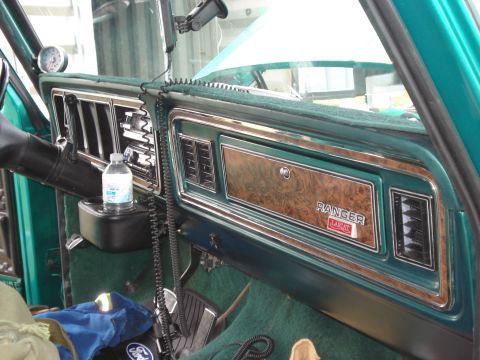 1979 Ford F-150 - The interior of a green truck shows a "Ranger Lariat" badge on the dashboard.