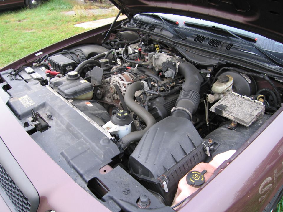 Engine bay of a 1991 Ford Crown Victoria LTD, showing the V8 engine, air intake, and various fluid reservoirs