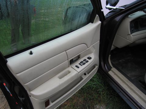 1991 Ford LTD Crown Victoria - Interior view of a 1991 Ford Crown Victoria LTD, showing the driver's side door panel and controls.