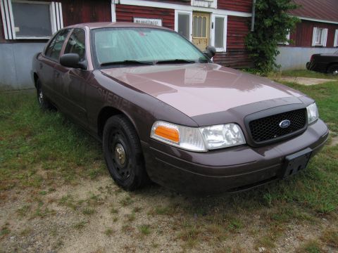1991 Ford LTD Crown Victoria - Brown Ford Crown Victoria Police Interceptor with "SHERIFF" text on the door is parked outside a building.