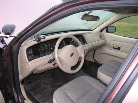 1991 Ford LTD Crown Victoria - The interior of a Ford Crown Victoria, likely a police car, is shown from the passenger side.
