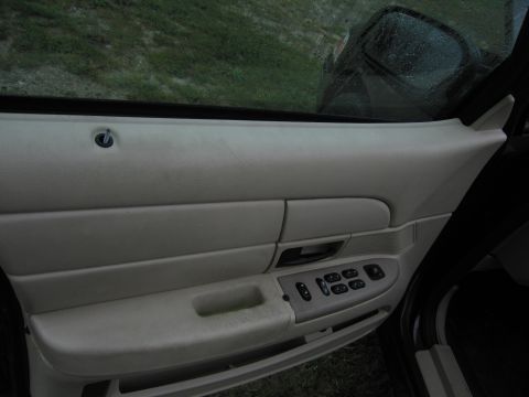 1991 Ford LTD Crown Victoria - The interior door panel features power window controls and a lock knob, with a view of the exterior through the window.