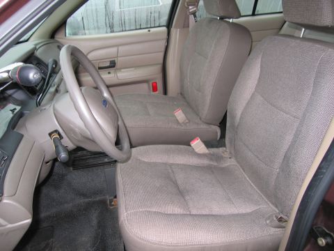 1991 Ford LTD Crown Victoria - Interior view of a police car, focusing on the front seats and steering wheel.