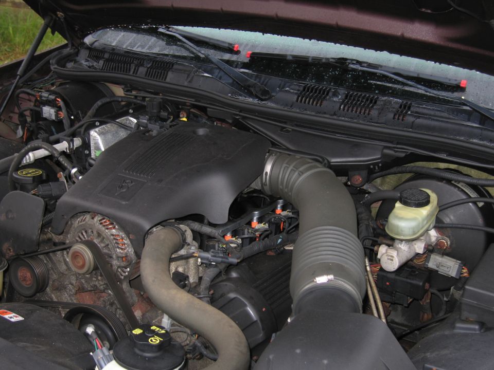 Engine bay of a Ford Crown Victoria, showing the V8 engine, air intake, and brake fluid reservoir