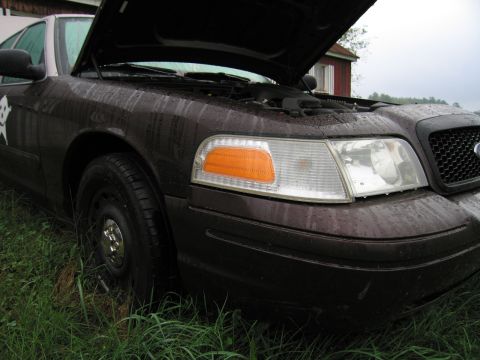 1991 Ford LTD Crown Victoria - A 1991 Ford Crown Victoria LTD sits in the rain with its hood ajar, revealing the engine bay.
