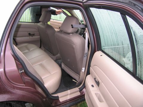 1991 Ford LTD Crown Victoria - Interior view of a 1991 Ford Crown Victoria LTD, highlighting the tan seats and door trim.