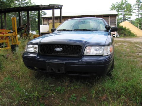 1991 Ford LTD Crown Victoria - This Ford Crown Victoria has a black grille and appears to be from the early 2000s.