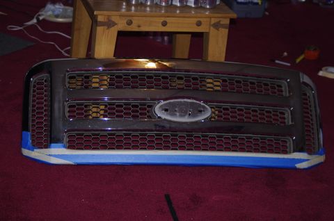 1999 Ford F-250 - Ford F-Series truck grille, likely from a 2005-2007 model, with tape applied to the lower section.