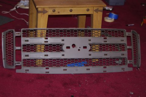1999 Ford F-250 - A disassembled Ford truck grille is shown, likely before installation or repair.