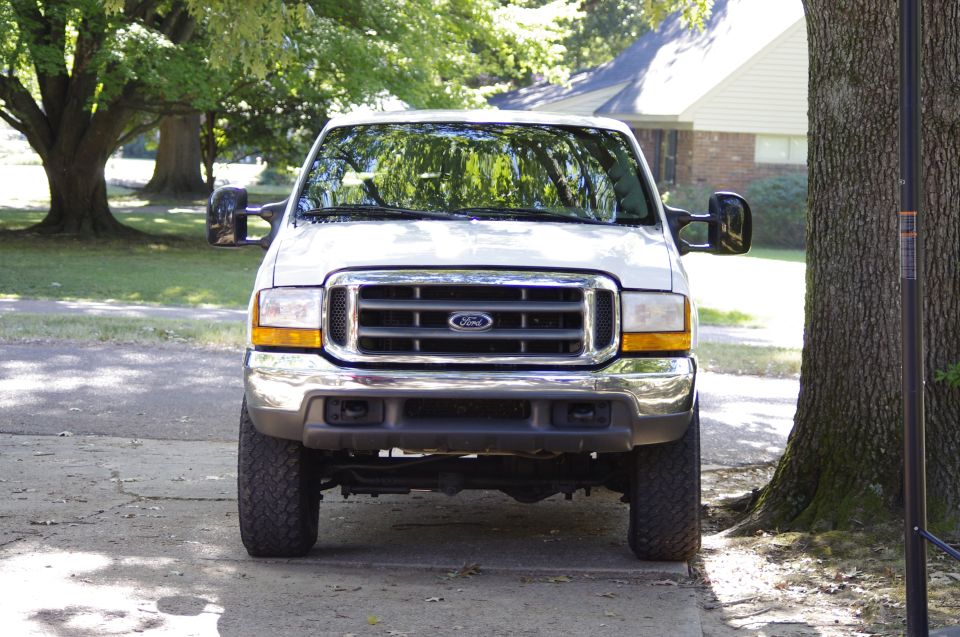 Front view of a white Ford Super Duty truck parked outside