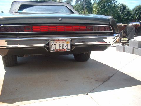 1970 Ford Torino - Rear view of a dark green 1970 Ford Torino convertible, showing its taillights and license plate.