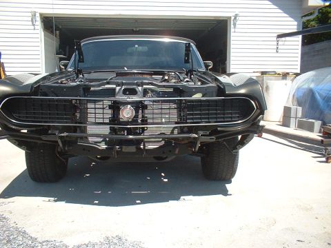 1970 Ford Torino - Front view of a 1970 Ford Torino with its hood open, showing the grille and radiator.