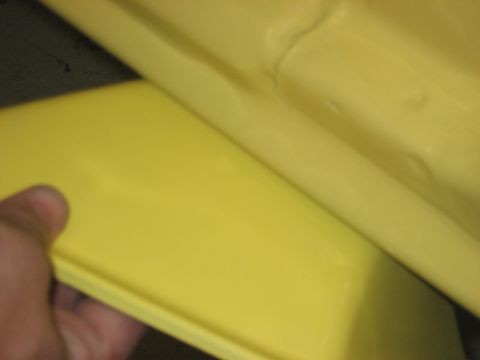 1978 Ford Bronco - A hand touches a yellow interior panel of a vehicle, with a SUPERMOTORS watermark visible.
