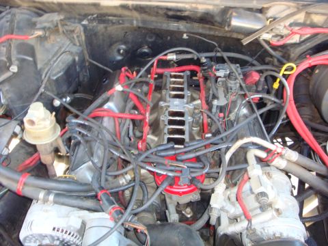 1989 Ford Bronco - Close-up view of a vehicle's engine bay, showing various components and wiring.