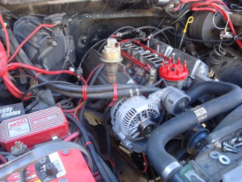 1989 Ford Bronco - Close-up of a vehicle's engine bay, various aftermarket components and wiring.