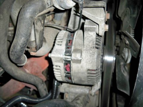1995 Ford F-150 - Alternator and fan belt assembly visible in the engine compartment.