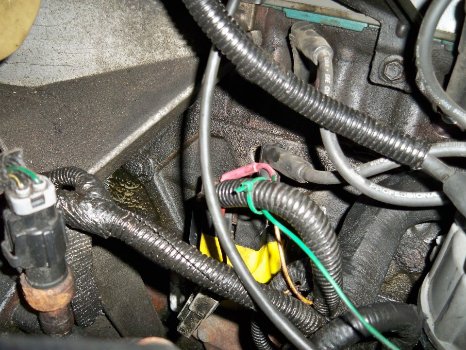 Close-up of engine wiring, spark plug wires, and connectors