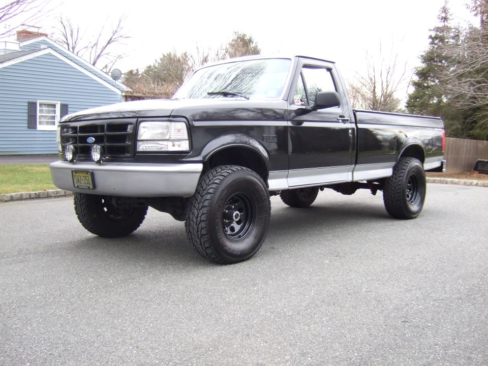 Black 1995 Ford F-150 pickup truck, 3/4 front view