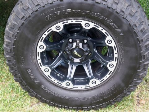 1995 Ford F-150 - Close-up of a black aftermarket wheel with BFGoodrich Mud-Terrain T/A tires, a "Dick Cepek" center cap.