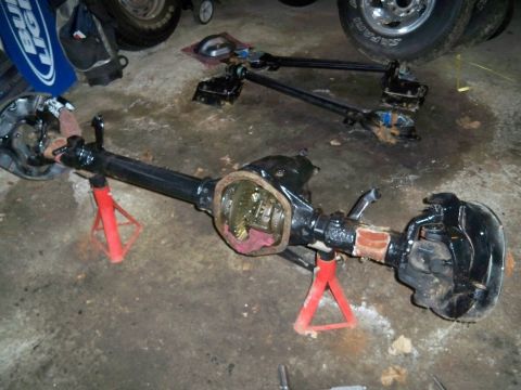 1995 Ford F-150 - A differential axle assembly is shown on jack stands, with a second assembly visible in the background, suggesting a rebuild or repair proc…