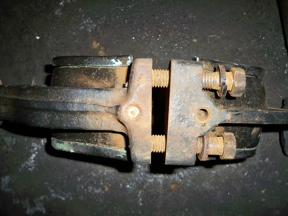 Rusty brake caliper held in a vise