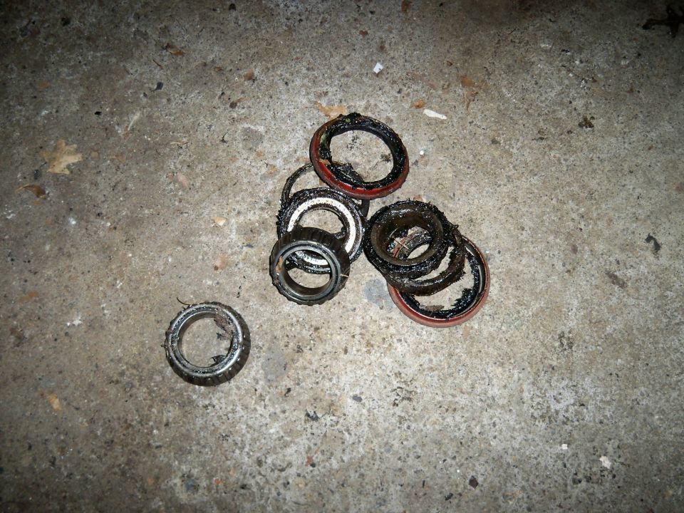Pile of used wheel bearings and seals on concrete floor