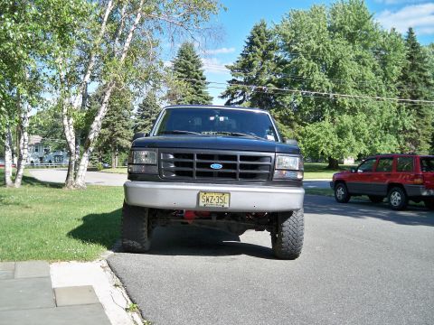 1995 Ford F-150 - Front view of a lifted 1995 Ford F-150 pickup truck parked on a residential street.