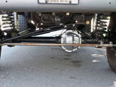 1995 Ford F-150 - Undercarriage view of a vehicle's rear axle and suspension system, showing modified components.