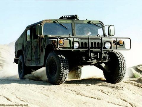 1998 Ford Crown Victoria - A green Humvee kicks up dust as it drives off-road.
