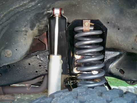1995 Ford F-150 - Close-up view of a vehicle's front suspension system, showing a coil spring and shock absorber.