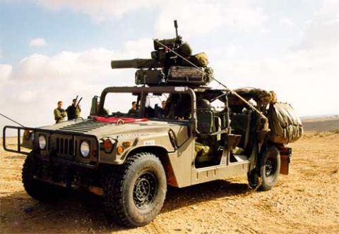 1998 Ford Crown Victoria - Military Humvee equipped with a weapon system and soldiers in a desert environment.