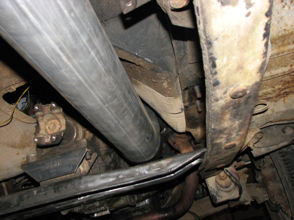 Underside view of a vehicle's exhaust pipe and suspension components
