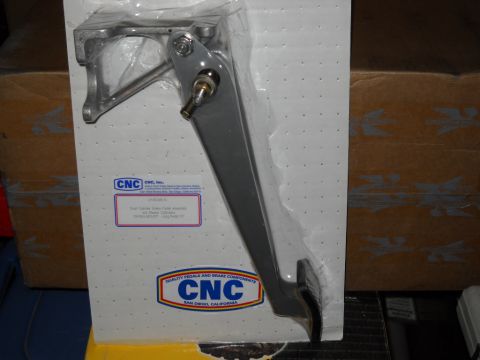1954 Ford F-100 - A CNC brake pedal assembly is shown packaged for sale, with visible branding and part information.