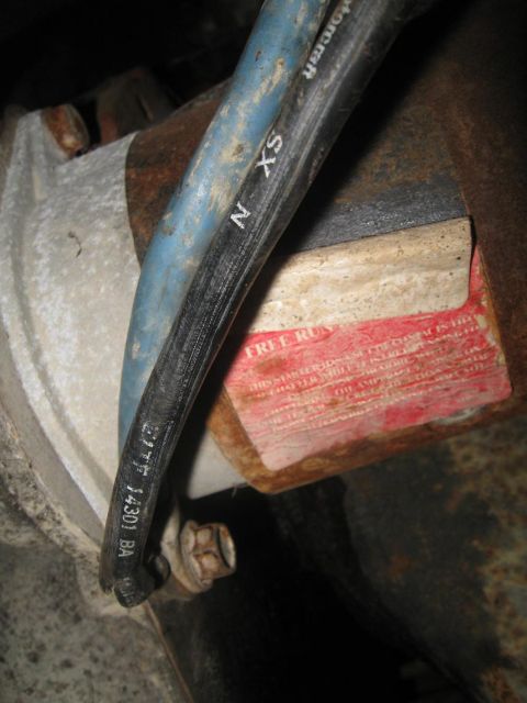 1981 Ford Bronco - Close-up of a Motorcraft part, likely from a vehicle's drivetrain, with a red warning label.