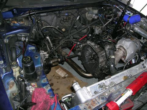 1995 Ford Probe - Custom turbocharger installation in a vehicle's engine bay, modified exhaust and intake components.