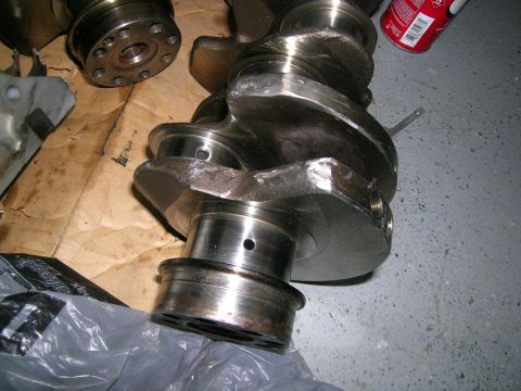 1995 Ford Probe - Close-up of a used engine crankshaft, likely for a performance build.