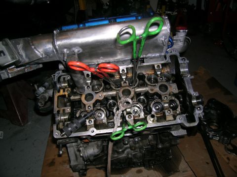 1995 Ford Probe - Engine block with custom intake manifold and tools, showing internal components.
