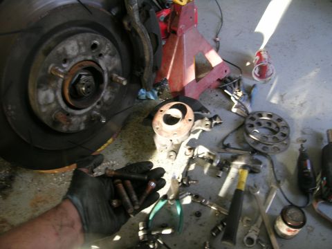 1995 Ford Probe - Car brake assembly parts and tools are laid out on the floor, suggesting a repair or upgrade is in progress.