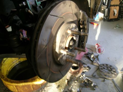 1995 Ford Probe - Front brake assembly with rotor and caliper, likely during maintenance or repair work.